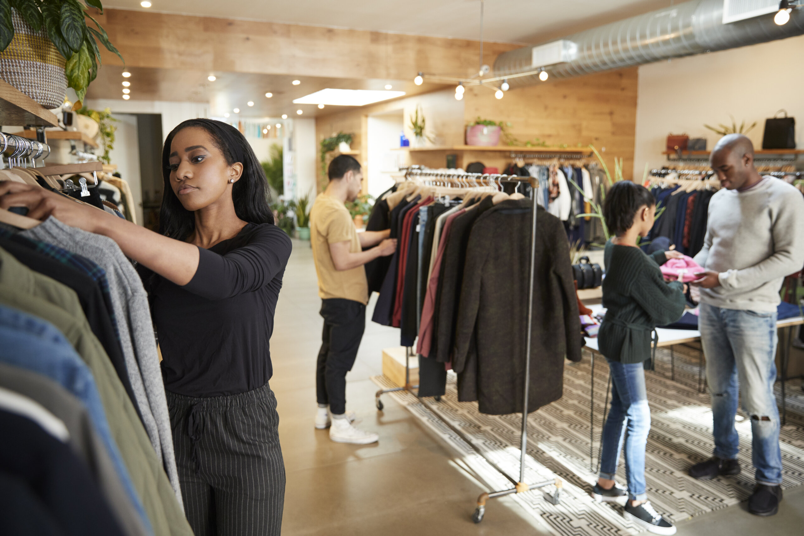 Customers and staff in a busy clothes shop