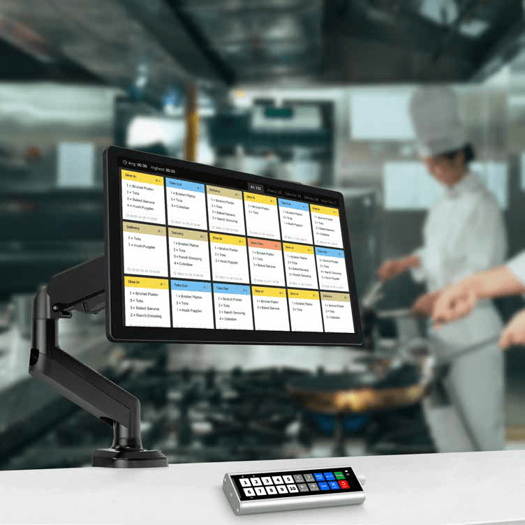 Elys Display mounted on a stand with the bump bar on the table below in a kitchen situation with chefs in white uniforms cooking in the background